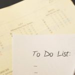 Close-up of a calendar and to-do list on a desk, emphasizing planning and organization.