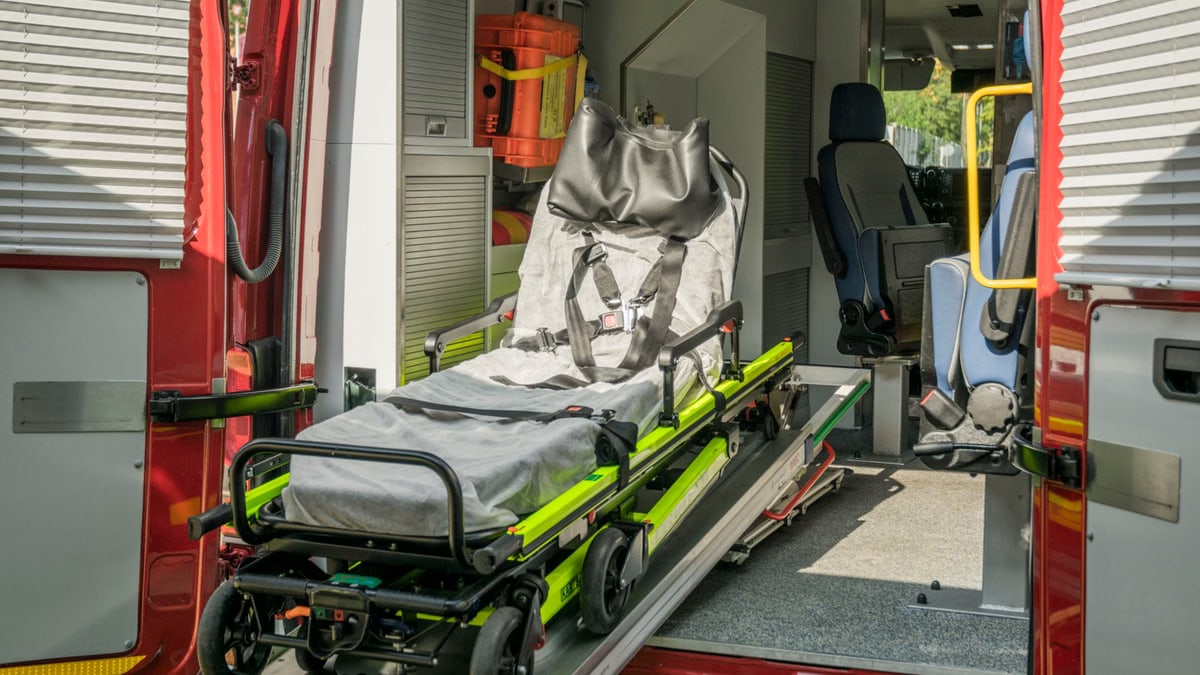 Inside view of a modern emergency ambulance showing a stretcher for patient transport.